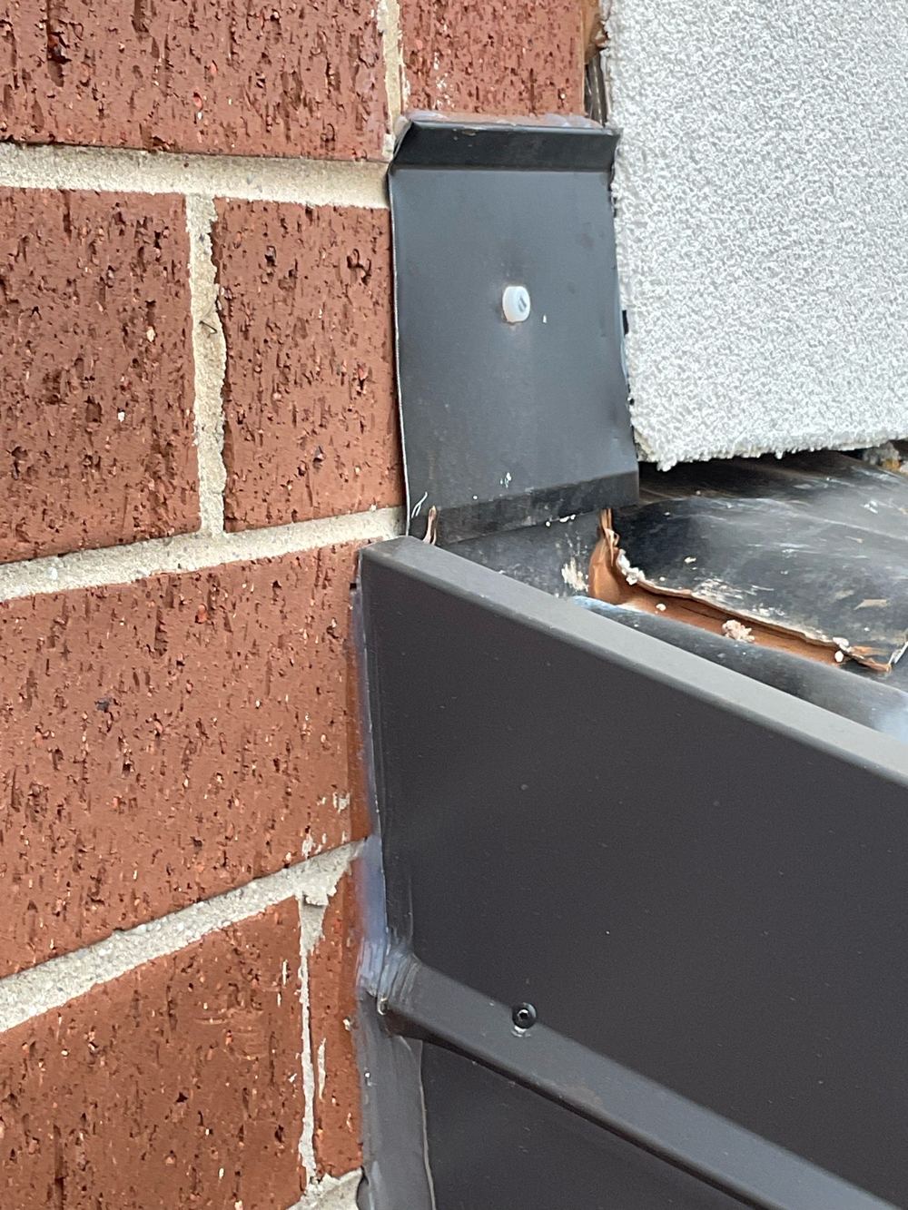 Flashing against the cladding left unsealed along its top edge, Strathtulloh