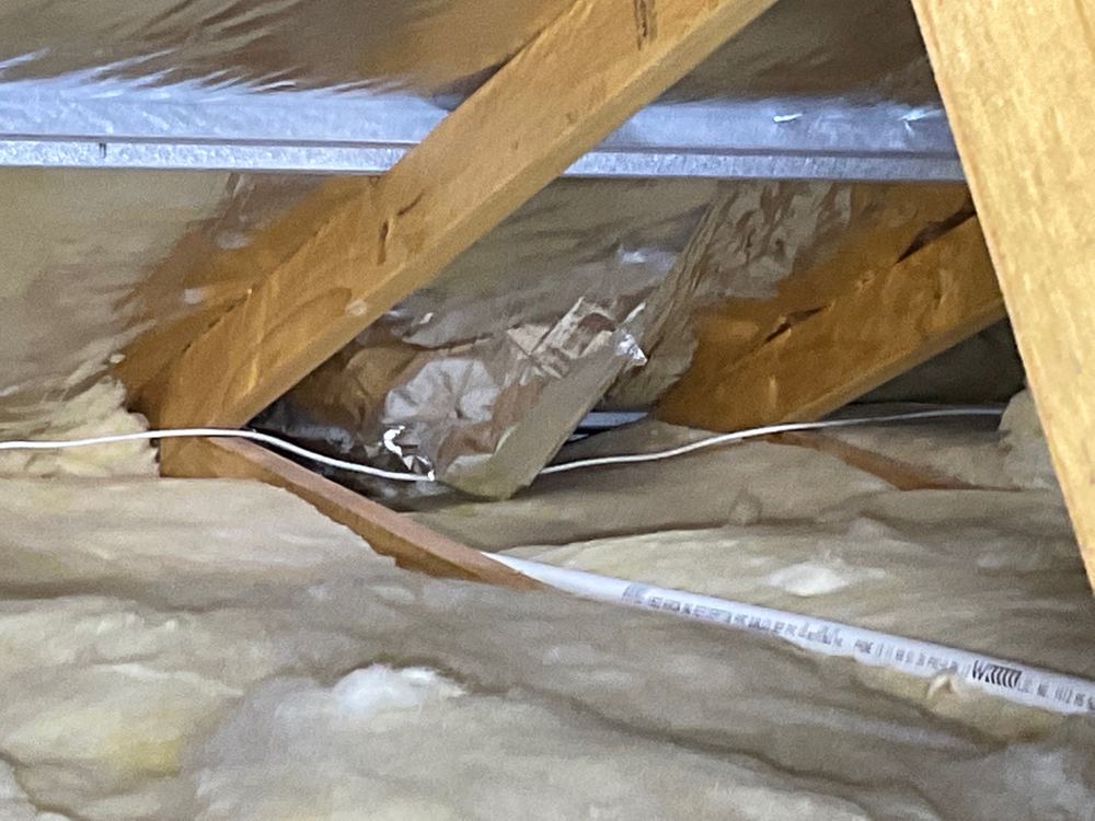 Cut sarking in the roof space that leaves the ceiling open to leaks, found during a pre-handover inspection in Strathtulloh