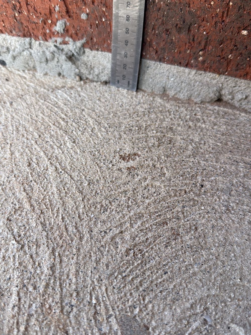 Bottom mortar joint thicker than the 20mm the tolerance allows, found during a pre-handover inspection in Strathtulloh