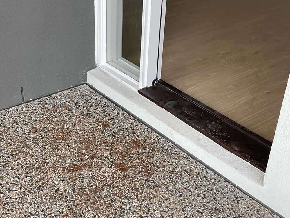 Weep holes sitting less than 50mm above the paving next to them, found during a pre-handover inspection in Strathtulloh