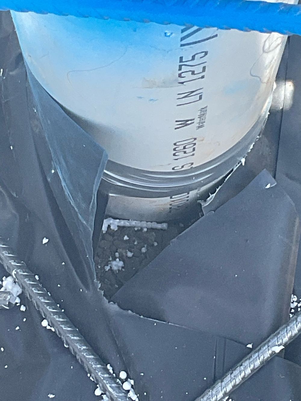 Plumbing pipe passing through the membrane with no sleeve or tape seal, found during a slab pre-pour inspection in Strathtulloh